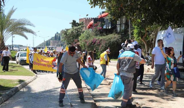 1 Mayıs kutlamalarında yürüyen işçilerle çalışan işçiler aynı karede